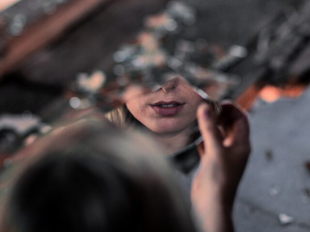 a person looking at a mirror